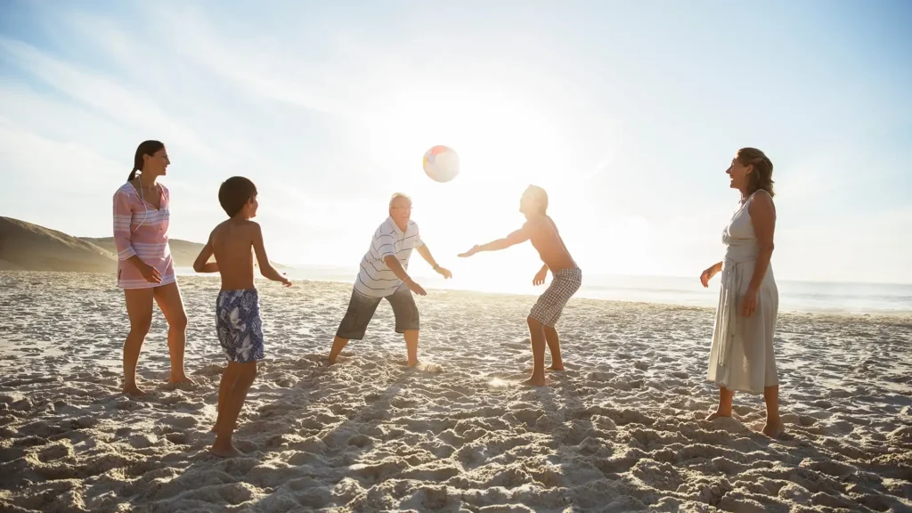 Raleigh Hand to Shoulder Center Photo of active healthy family playing beach volleyball